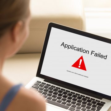 restoro system optimizers woman on laptop application failed error on screen 